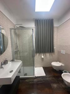 a bathroom with a shower and a sink and a toilet at B&B Caricone in Orta Nova