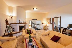 a living room with a couch and a fireplace at Villa Thalassea in Kalami