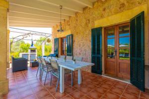 a dining room with a table and chairs on a patio at Mercader in Alcudia