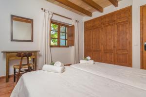 a bedroom with a bed and a desk and a window at Mercader in Alcudia +54 photos