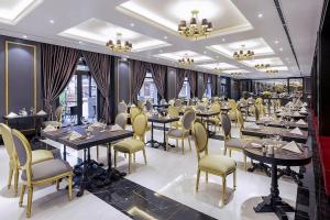 a restaurant with tables and chairs in a room at Hotel Sapa Square, Affiliated by Meliá in Sapa