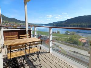 a balcony with two benches and a view of the water at Lakeview 4BR with Sauna & EV Parking in Åre