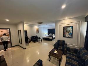 a living room with a couch and a bed in a room at Hotel the Jeeven's in Sialkot +25 photos