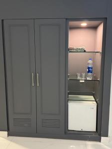 a gray cabinet with a bottle of water in it at Hotel the Jeeven's in Sialkot