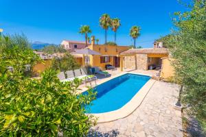 a villa with a swimming pool and a house at Raco De Can Pep in Inca