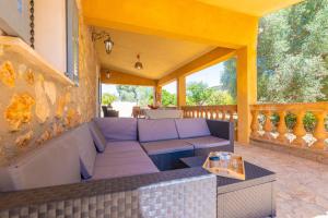 a patio with a couch and a table on a porch at Raco De Can Pep in Inca
