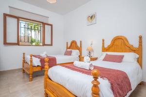 a bedroom with two beds and a window at Raco De Can Pep in Inca +25 photos