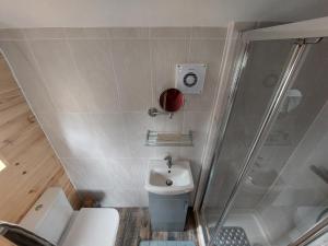 a small bathroom with a sink and a shower at Knocknafallia in Cappoquin +35 photos