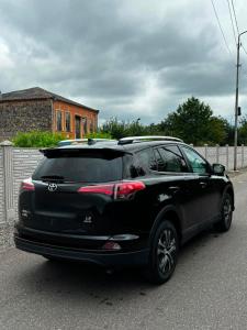 a black lexus suv parked in a parking lot at Green Palace Kutaisi in Kutaisi