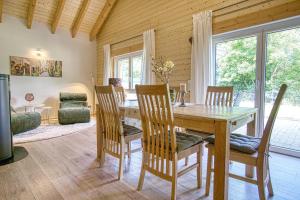a dining room with a wooden table and chairs at Ferienhaus Immenhof in Rieden
