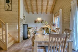a dining room with a wooden table and chairs at Ferienhaus Immenhof in Rieden +20 photos