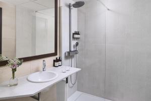 a bathroom with a sink and a shower at NH Ciudad de Santander in Santander