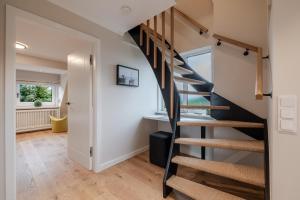 a spiral staircase in a home with a hallway at Dolle's Hüs in Wenningstedt