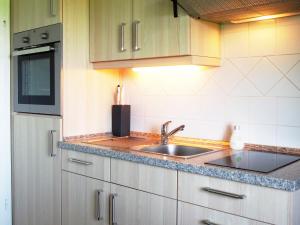 a kitchen with a sink and a counter at Ferienwohnung Wattwurm Ockholm in Ockholm +6 photos