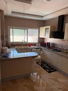 a kitchen with a sink and a counter top at Appartement de luxe, Résidence les 5 étoiles, Bizerte in Zarzouna