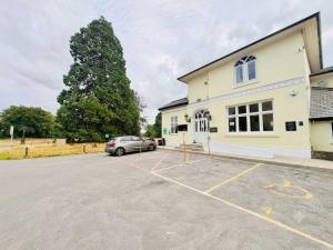a car parked in a parking lot in front of a building at Wrexham Llyndir Hotel by Belvilla in Rossett