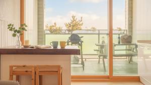 a kitchen with a view of a patio with a table at Yangyang Bono Pet-friendly Pension in Yangyang