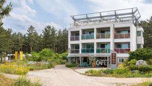 a white building with a cafe on the side of it at Yangyang Bono Pet-friendly Pension in Yangyang