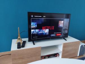 a flat screen tv sitting on top of a tv stand at Gosen appart in Athis-Mons
