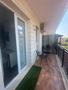 a patio with a table and chairs on a balcony at B&B Caricone in Orta Nova +4 photos
