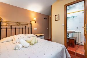 a bedroom with a large bed and a sink at Apto rurales y habitaciones MONTE CAORU - CABRALES apartahotel in Arenas de Cabrales