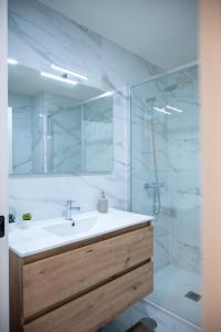 a bathroom with a sink and a shower with a mirror at La Maison de Ré in Vila Real +53 photos