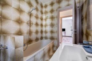 a bathroom with a tub and a sink at The Nice Bright House in Palermo +38 photos