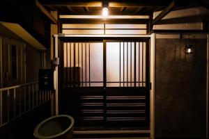 a door to a building with a light on it at 海と富士山を望む4名1棟貸し古民家宿 最大7名 鎌倉エリアの隠れ家 in Zushi +36 photos