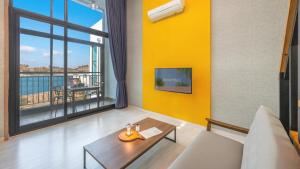 a living room with a table and a large window at Yeosu Arungeorida Ocean View Pension in Yeosu