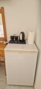 ein weißer Kühlschrank mit zwei Pfannen darauf in der Unterkunft Fountas Apartment in Parga