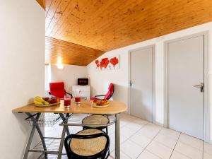 a dining room with a table and two chairs at Le Cornas in Vérin