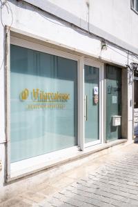 a store window with a sign on it at O Vilarealense Heritage Apartment in Vila Real