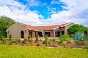 a house with a garden in front of it at Kasimba Boutique Hotel in Gaborone