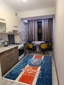 a kitchen with a table and chairs and a kitchen rug at Urban in Bishkek