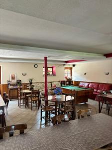 a room with tables and a pool table at Chambres d'hôtes chez Adam 