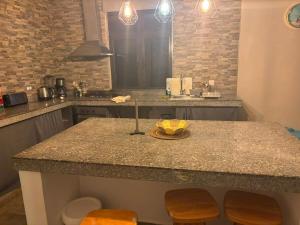 a kitchen with a counter with a bowl of fruit on it at House - Maison Blue Print- 2 bedrooms in Surinam