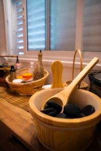 a wooden bowl filled with black stones on a kitchen counter at Green therapy - Wellness resort in Bet Dagan