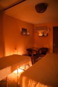 a room with two beds and a table and chairs at Green therapy - Wellness resort in Bet Dagan