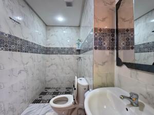 a bathroom with a toilet and a sink at Riad Ba brahim in Rabat