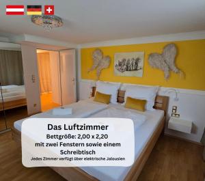 a bedroom with a large bed with yellow walls at Dreamly Suites Oslip in Oslip