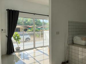 a sliding glass door with a view of a patio at เอกสิริ รีสอร์ต in Amphoe Tha Chana