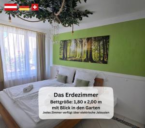 a bedroom with a bed with a poster on the wall at Dreamly Suites Oslip in Oslip