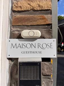 a sign on the side of a house with a mushroomose guest house at Maison Rosé in Hasselt