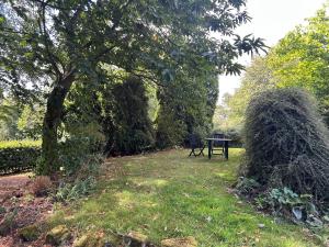 a park with a bench and a table in the grass at Annexe in Broomfield Barn in Swettenham