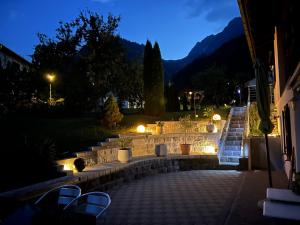 a patio with chairs and lights at night at Ferienwohnung Schneider in Vandans