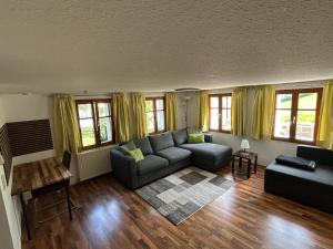 a living room with a couch and a table at Ferienwohnung Schneider in Vandans +10 photos