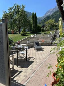 a patio with a table and a bench and stairs at Ferienwohnung Schneider in Vandans