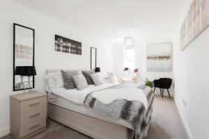 a white bedroom with a bed and a desk at Liver Building View in Liverpool +13 photos