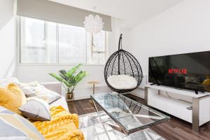 a living room with a couch and a tv at Liver Building View in Liverpool
