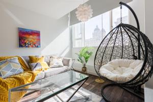 a living room with a swing and a couch at Liver Building View in Liverpool